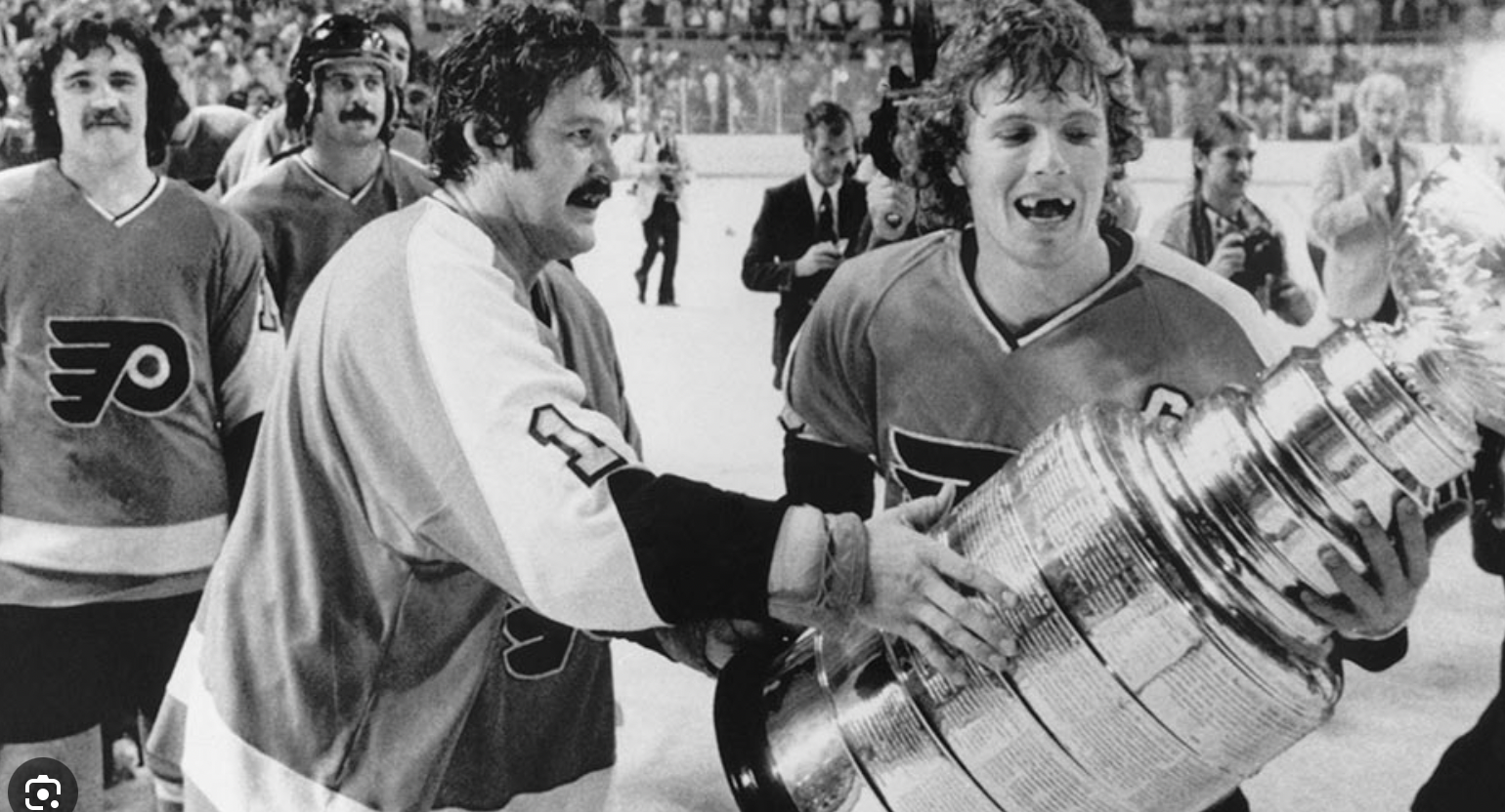 The Philadelphia Flyers' Bernie Parent, Bobby Clarke with the Stanley Cup ini1975.