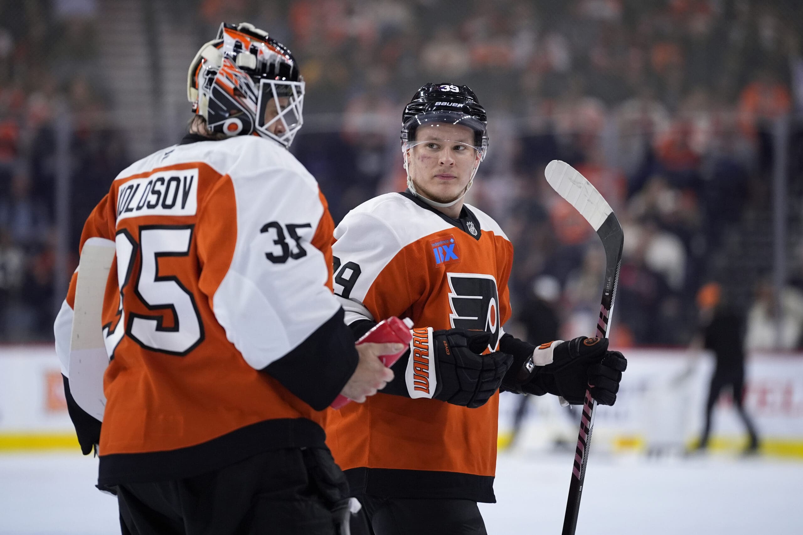 Philadelphia Flyers goalie Aleksei Kolosov on the ice with Matvei Michkov