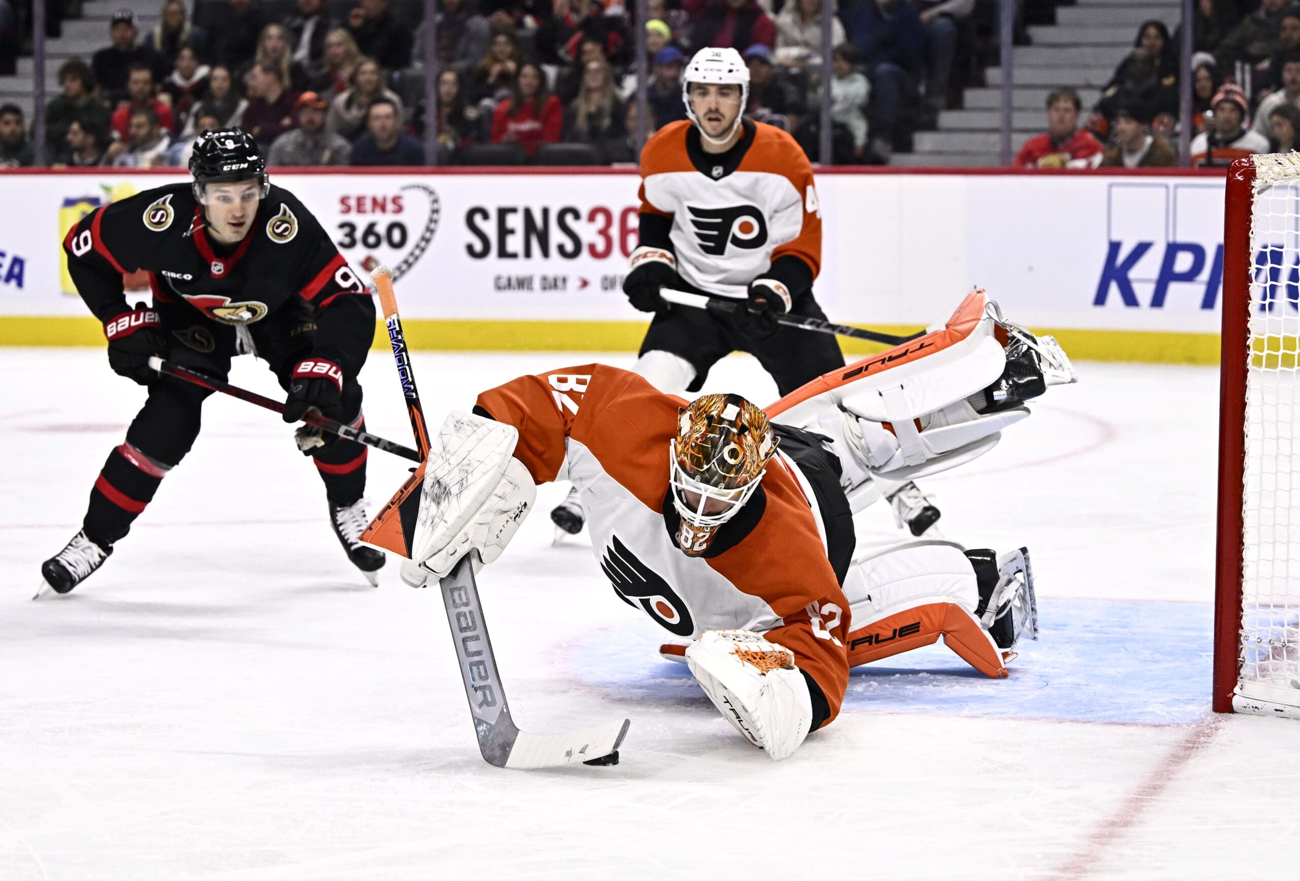 Philadelphia Flyers goalie Ivan Fedotov dives to his left to make a save against the Ottawa Senators.